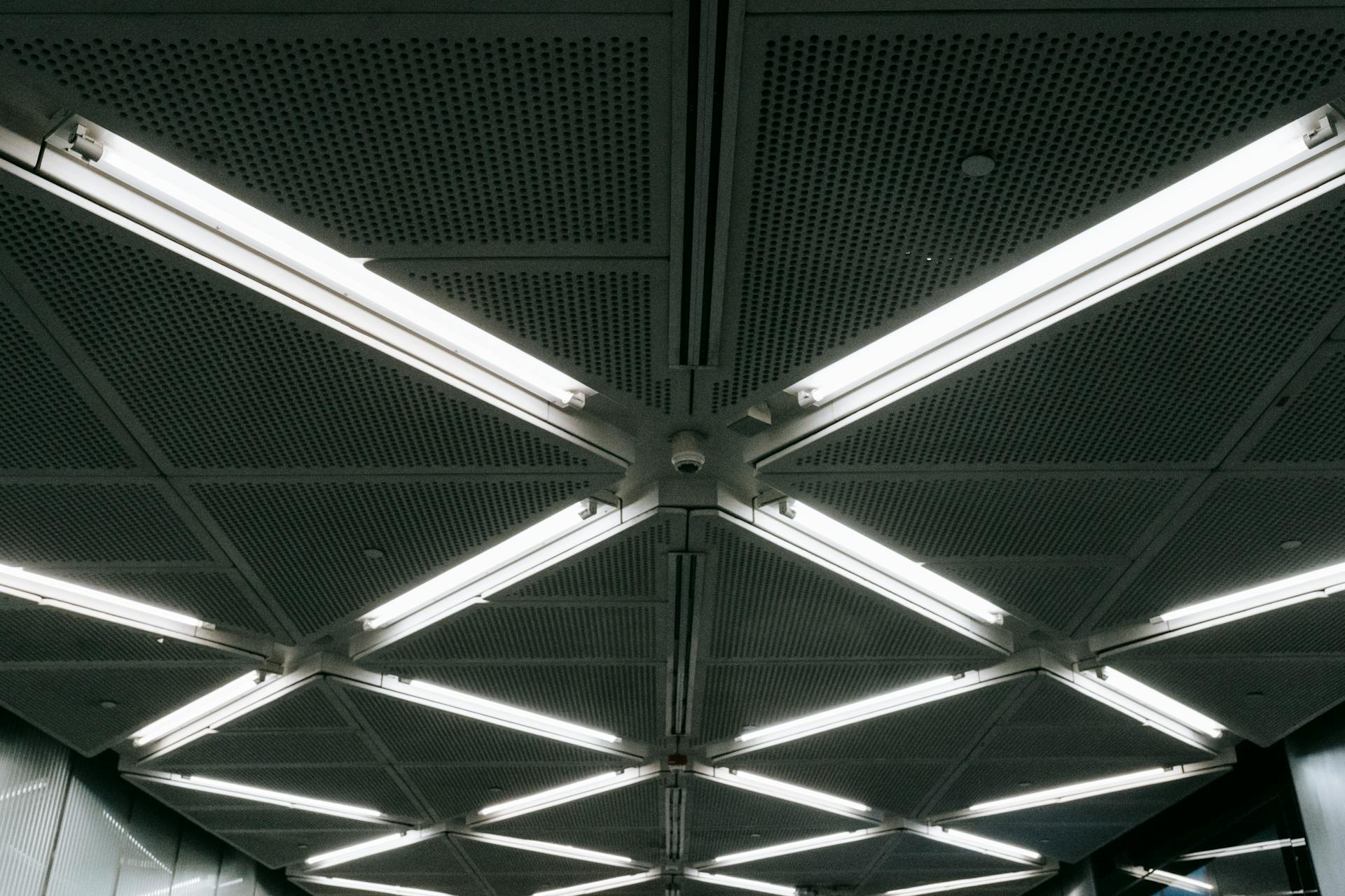 Metal ceiling with glowing lamps in underground garage