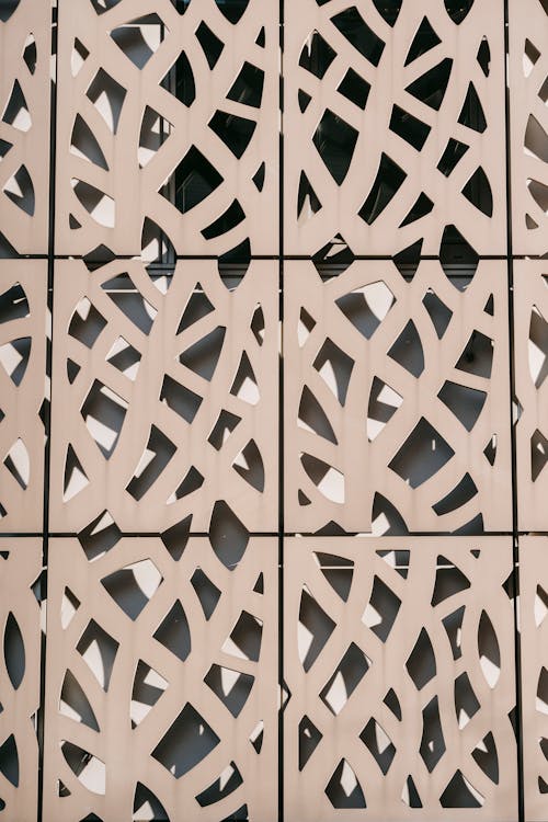 Abstract background of carved ornamental panel of modern building facade located in city on sunny day