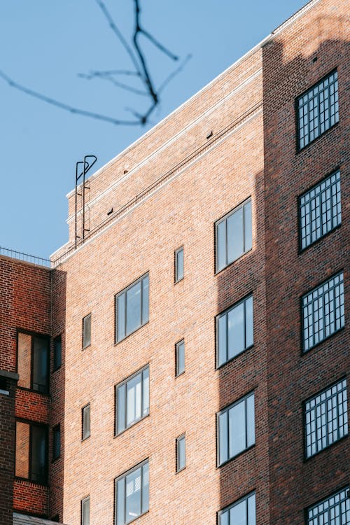 Facade of brick building in city residential district on sunny day