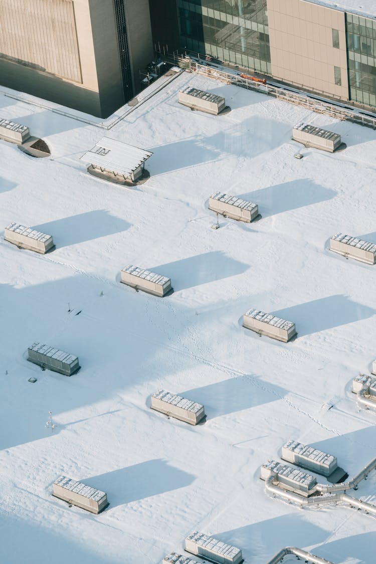 Snowy Roof Of Multistage Building With Concrete Blocks