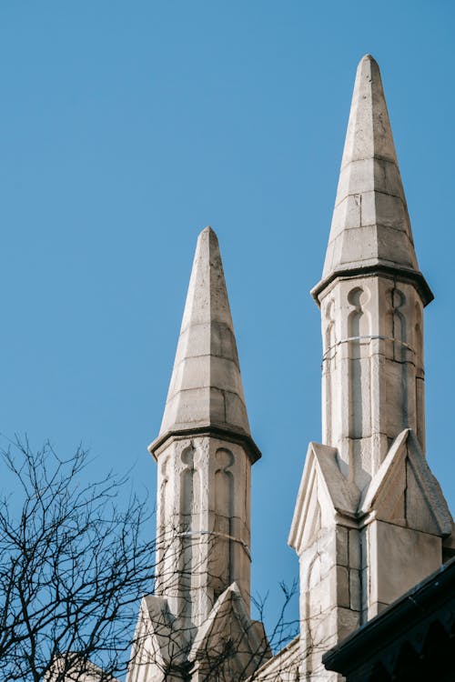 Old cathedral spires under blue sky