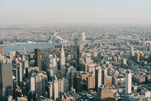 Spectacular drone view of New York City skyline with modern skyscrapers and towers near Hudson River on sunny day