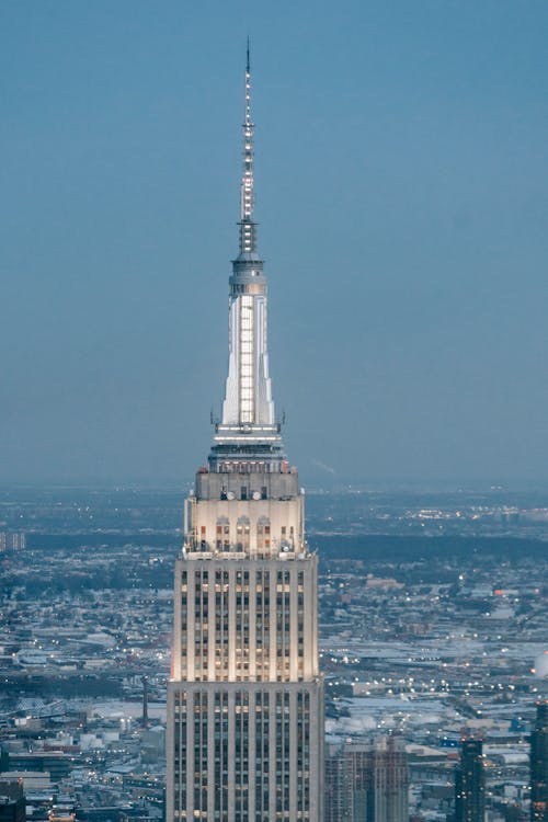 Modern office building with observation decks and spire located in urban core of New York metropolitan area