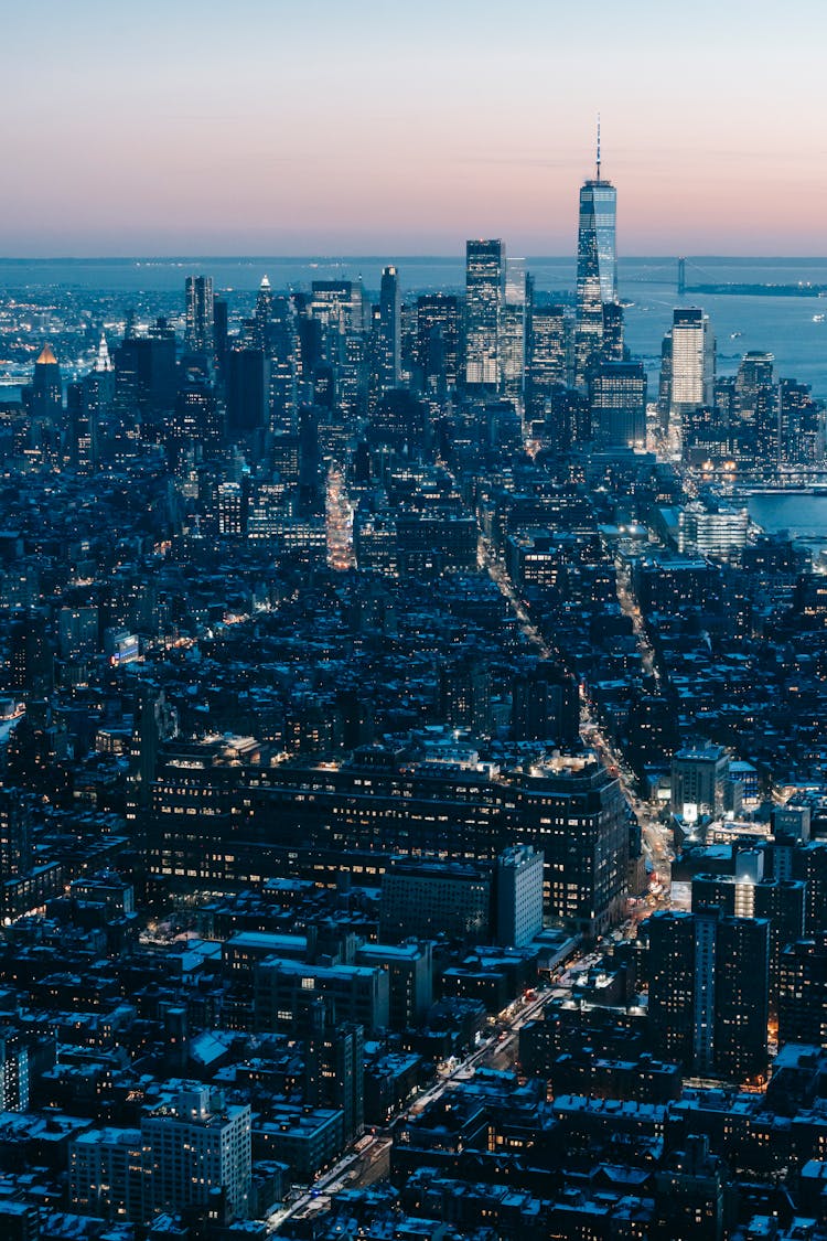 Manhattan Skyscrapers With Glowing Lights In Dusk