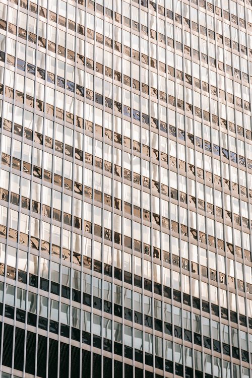 Free Full frame low angle exterior of modern multistory building with windows in daylight in town district Stock Photo