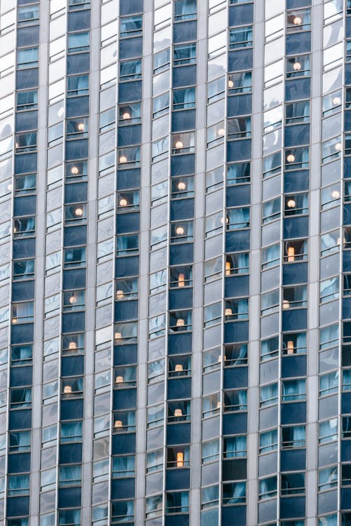 Full frame exterior of modern multistory skyscraper with windows located in town street in daytime