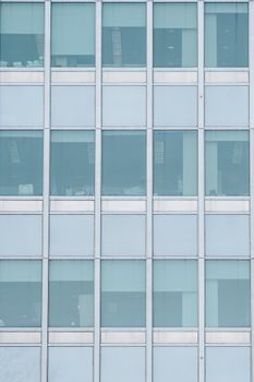 Full frame background of tall multistory building with transparent wall in central district