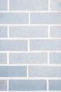 Full frame minimalist background of light gray wall with rows of bricks on wall