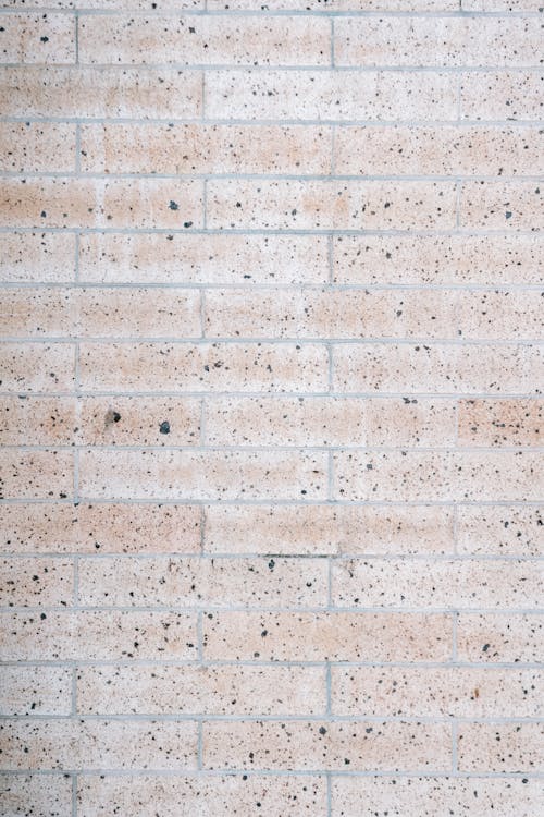 Brick wall with black dots on building