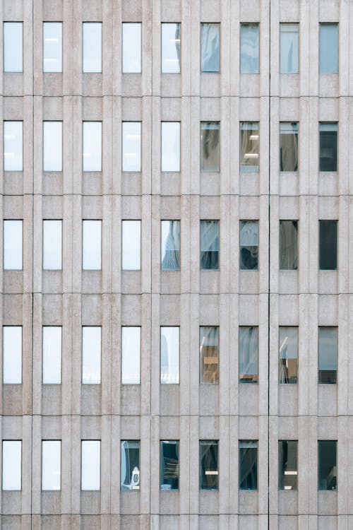 Free Full frame background of modern multistory office building with symmetric windows and reflection of tower Stock Photo