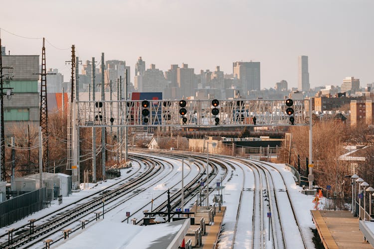 Railroad Tracks Covered With Snow Near Platform