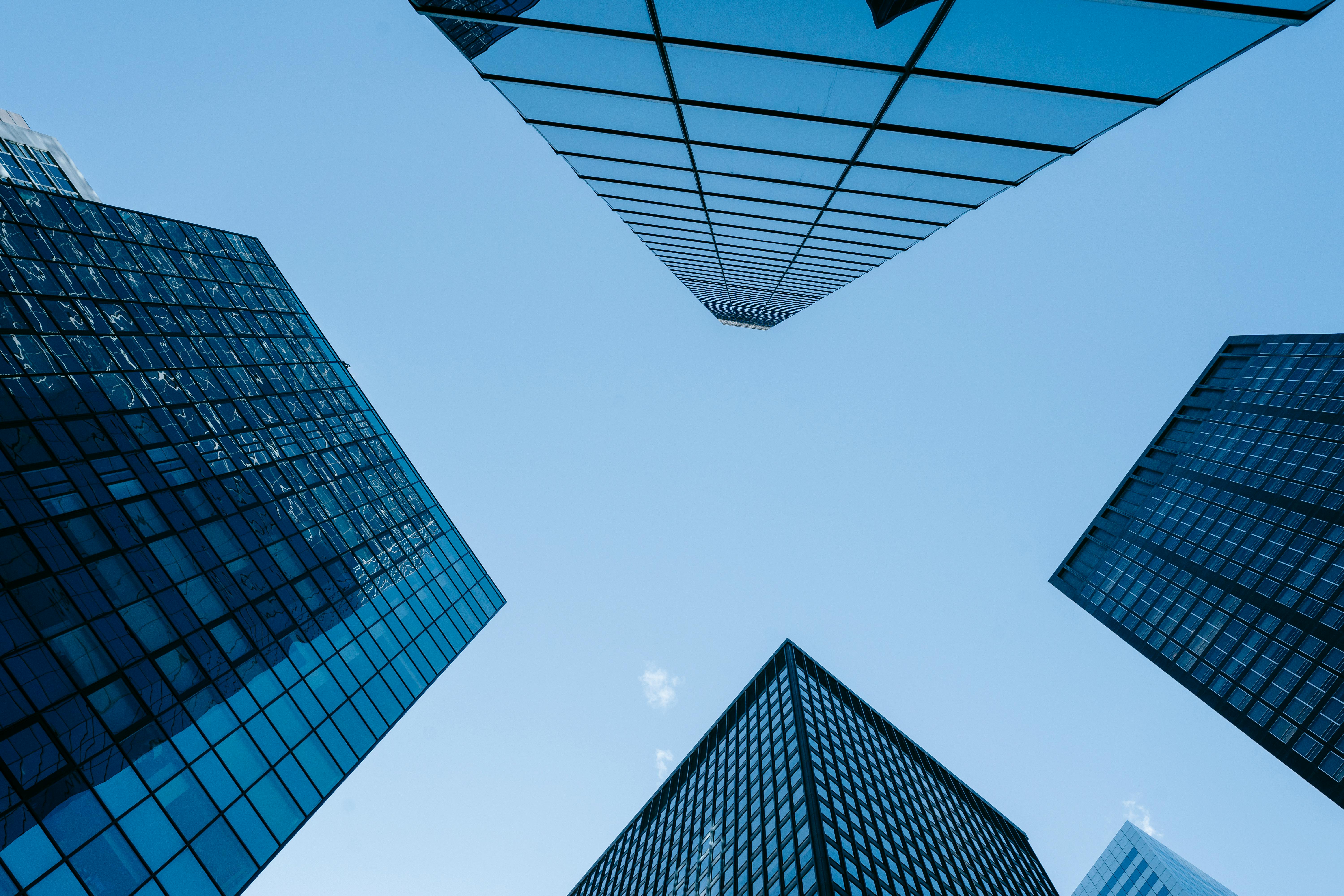 contemporary glass skyscrapers under cloudless blue sky