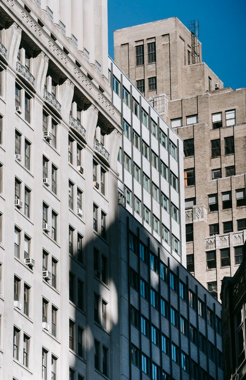 Free Low angle of high multistory residential buildings with concrete walls located in megapolis street Stock Photo