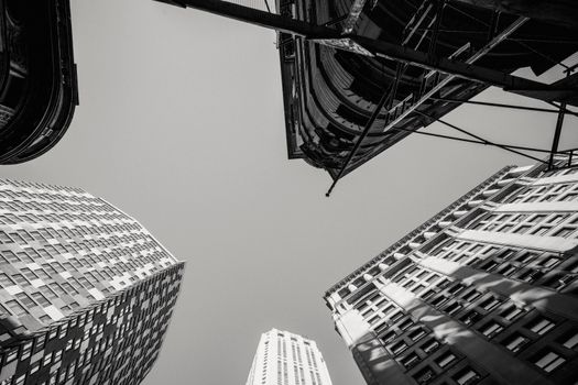 Black and white low angle of contemporary high multistory dwelling buildings located in city district