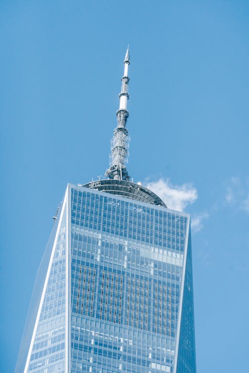 Free Low angle of modern high One World Trade Center with high telecommunication tower in Manhattan Stock Photo