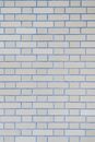 Textured full frame background of smooth stone wall with gray brick in rows