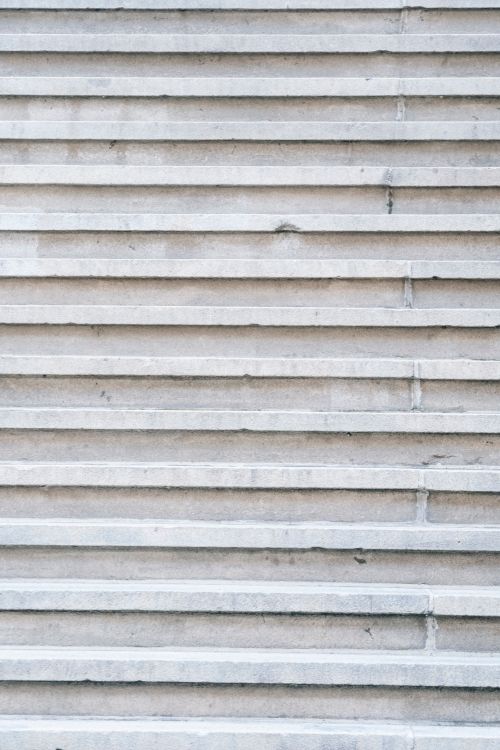 Free Full frame textured background of solid gray granite wall with narrow parallel planks Stock Photo