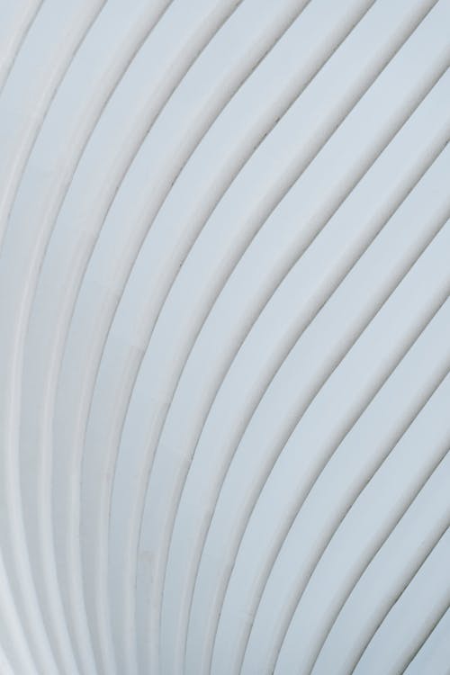 Minimalistic smooth white wavy wall with parallel lines for abstract geometric architectural background