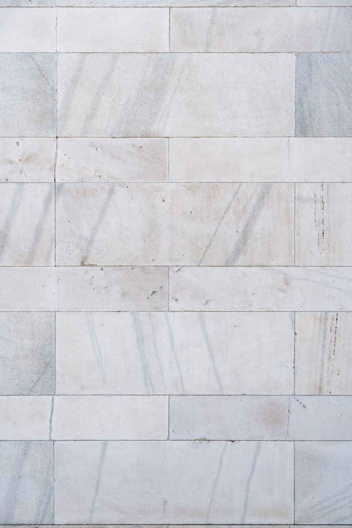 Close-up of grey marble floor tiles with soft mottling