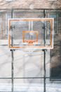 Basketball hoop hanging on backboard on sports ground