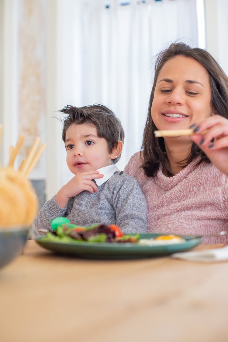 A Mother And Son Eating Breakfast