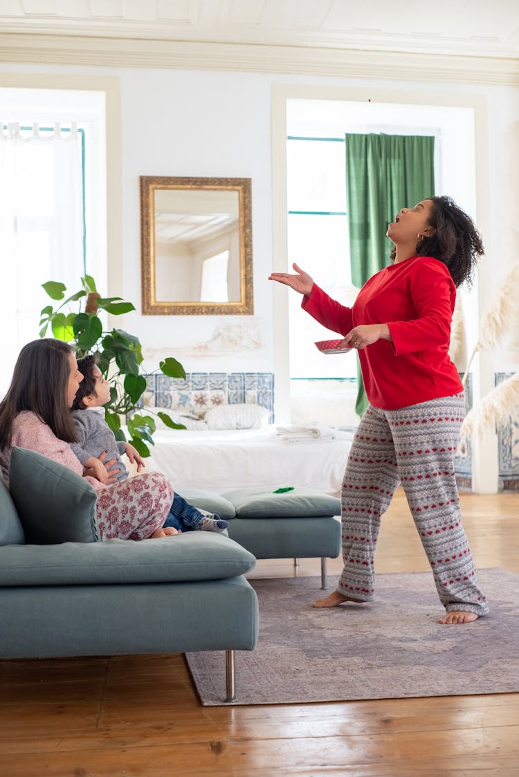 Women Playing With Their Son In A Living Room