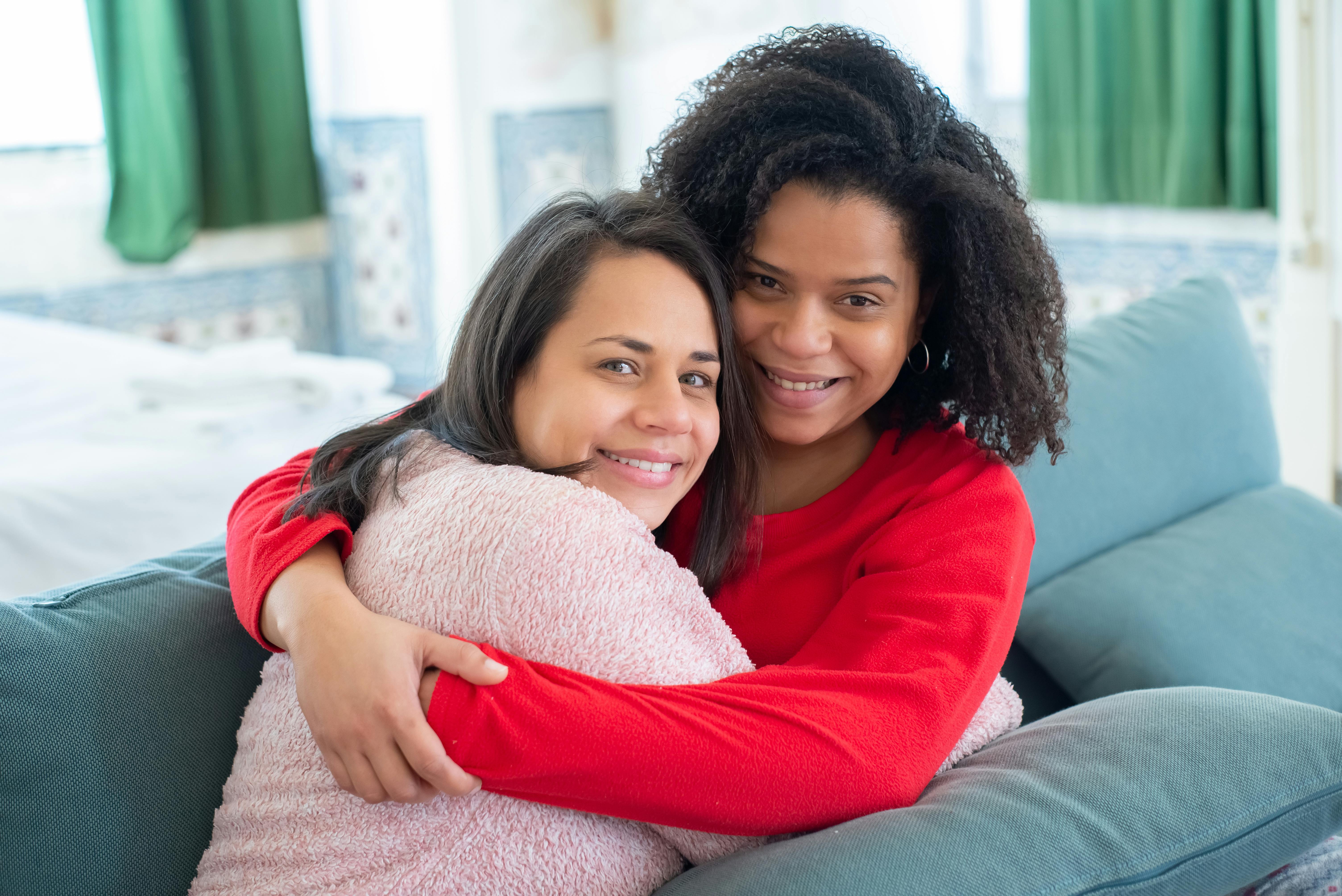 couple hugging on sofa at home