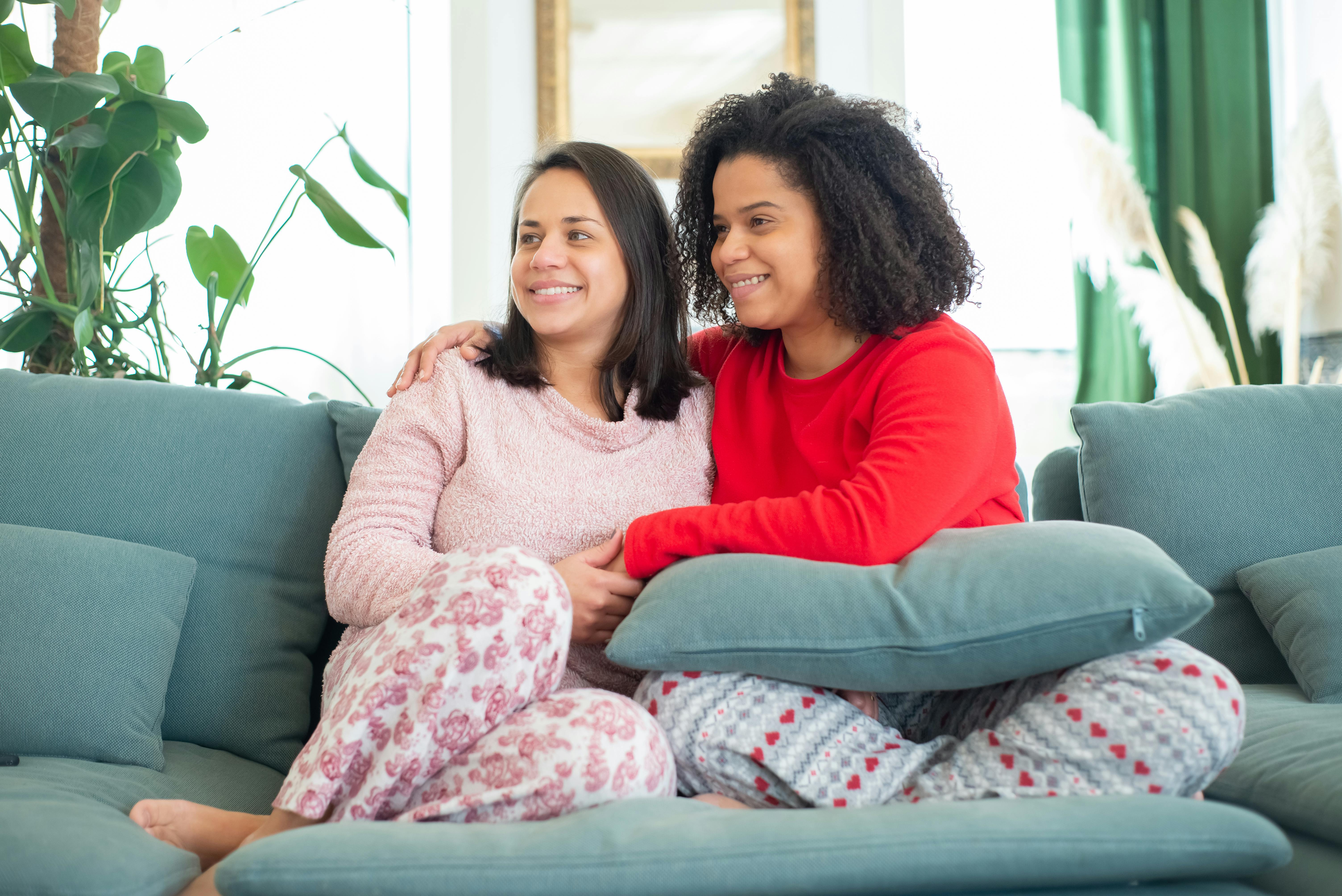 a couple sitting together on a sofa cou