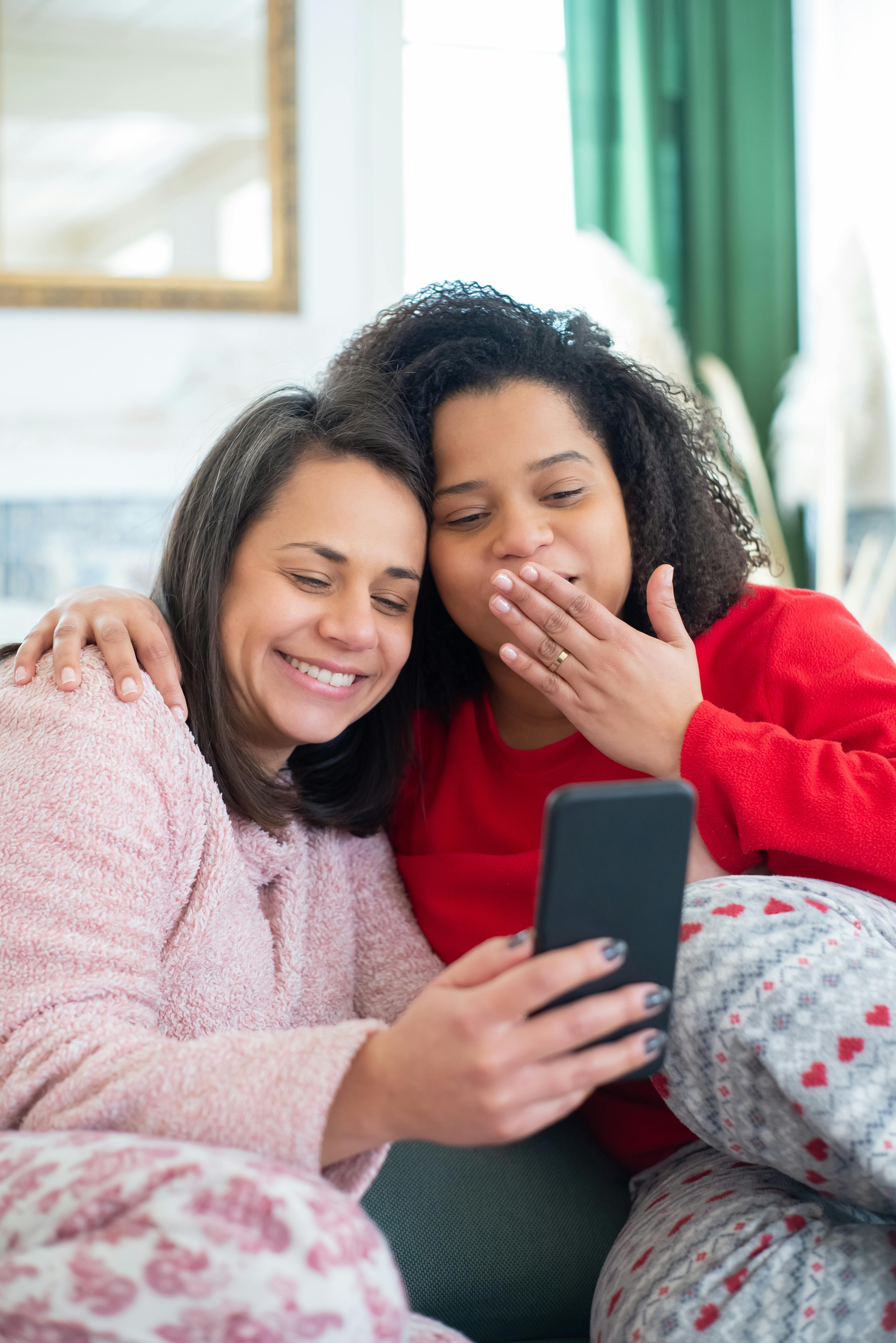 a couple looking at the screen of a mobile phone