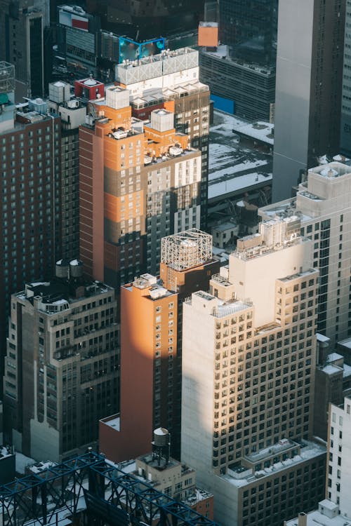 Aerial view of urban district with high concrete residential buildings located on streets of contemporary New York district