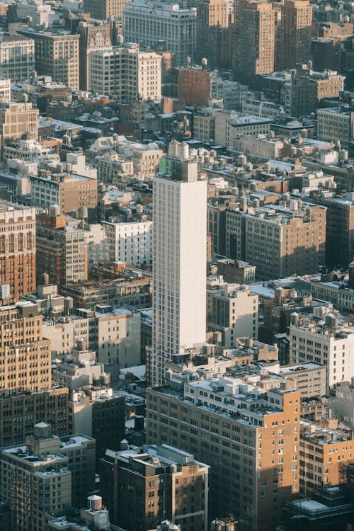 High multistory tower located among residential buildings in densely populated district of New York City
