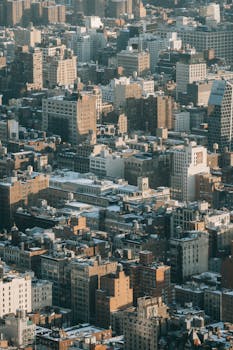 Aerial view of multistory residential buildings located on densely populated streets of megapolis district