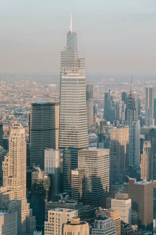 Free Contemporary creative high rise buildings and residential houses located on sunny street of modern New York City against cloudless sky Stock Photo
