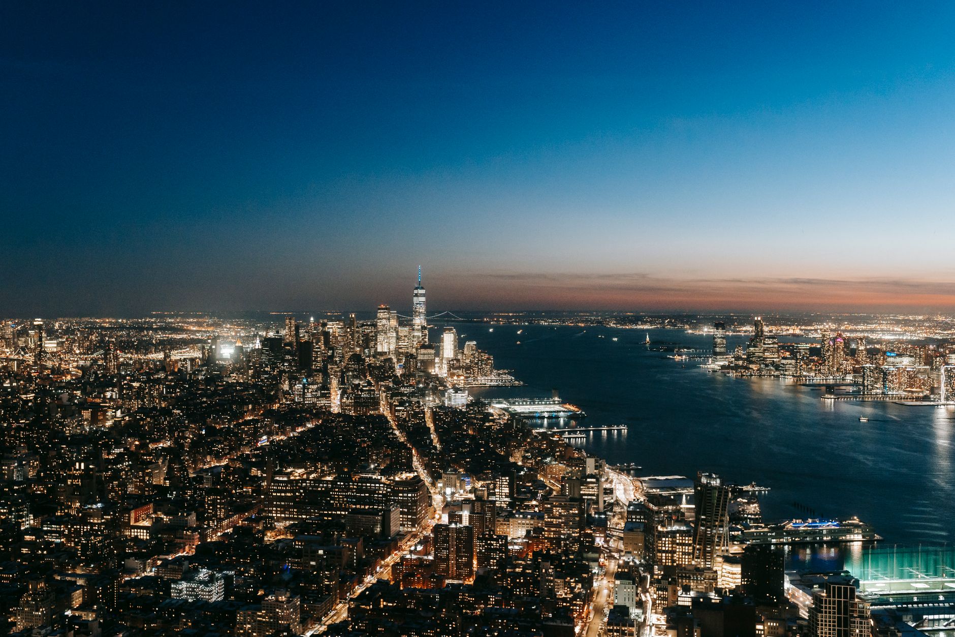 A minimalist high-altitude executive suite overlooking a global financial district during a clear twilight.