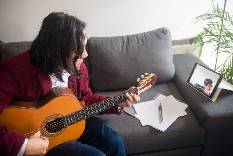 A Music Teacher Teaching Guitar Lessons Online