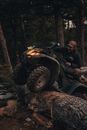 A Man Riding an All Terrain Vehicle in the Forest