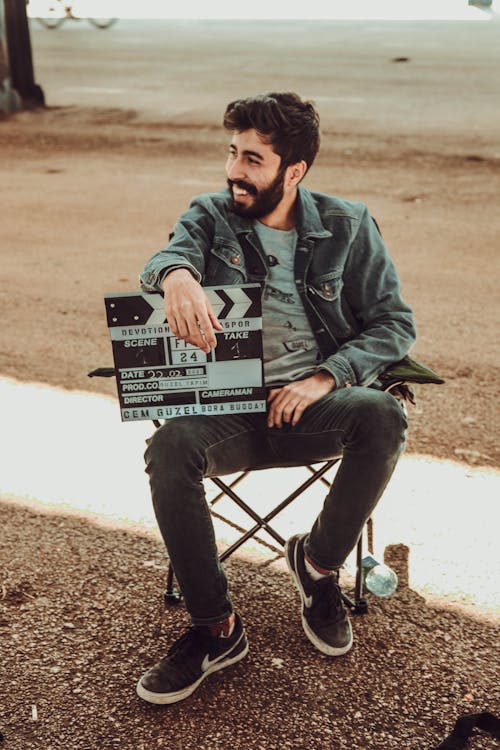 Free A Man Holding A Clapperboard Stock Photo