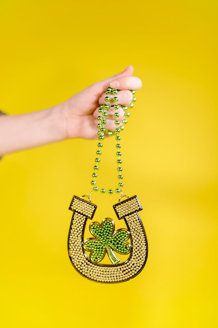 Person Holding A Hanging Decorative Shamrock 