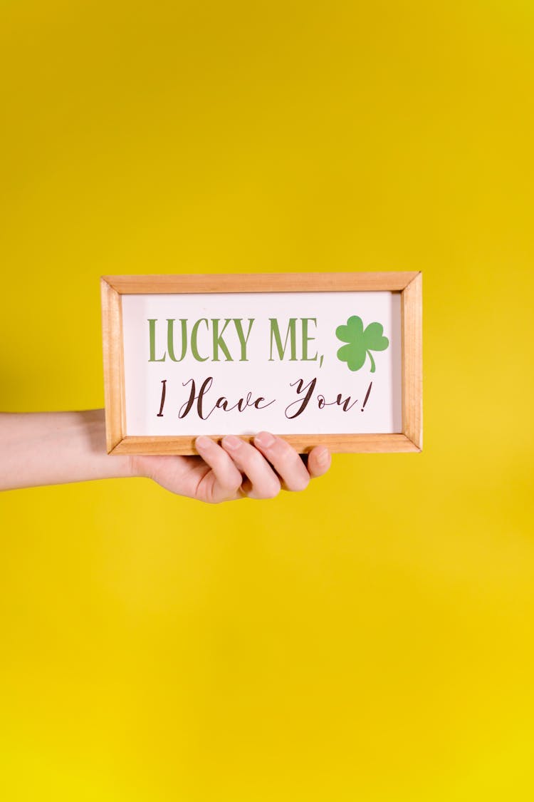 A  Person Holding A Framed Sign