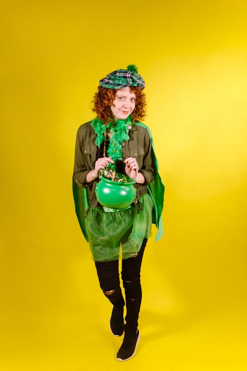 A Woman in Leprechaun Costume Holding a Pot of Gold