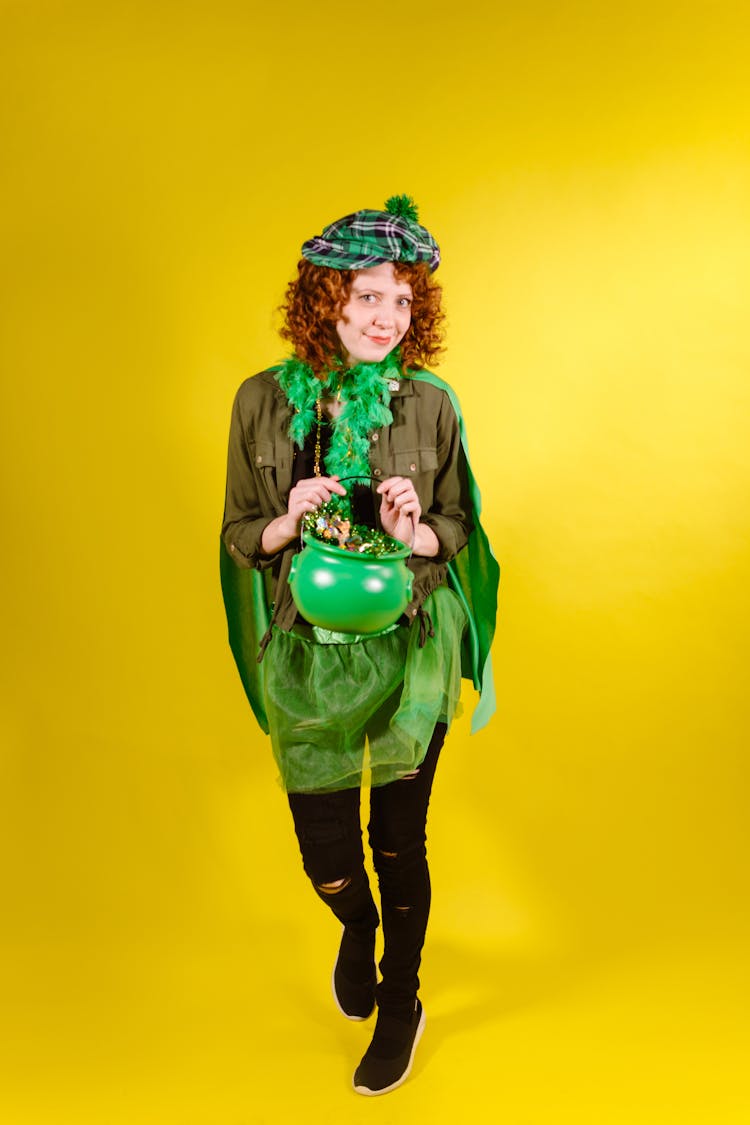 A Woman In Leprechaun Costume Holding A Pot Of Gold