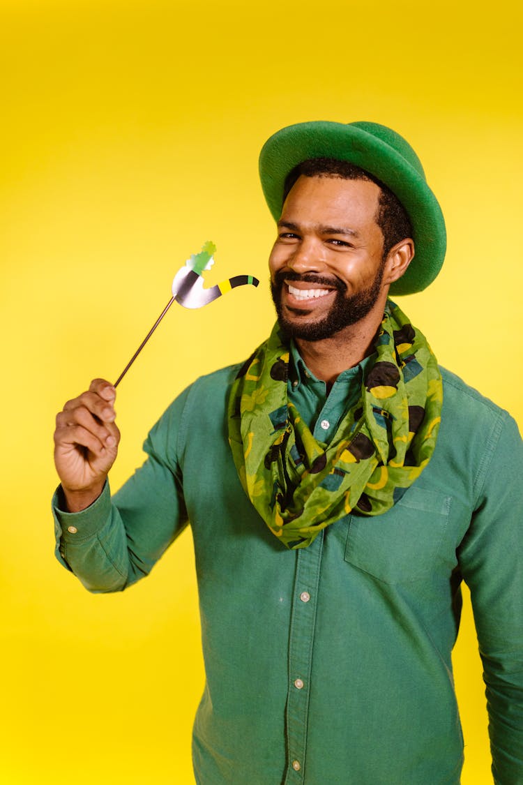 Man Wearing Green Hat Holding A Prop 