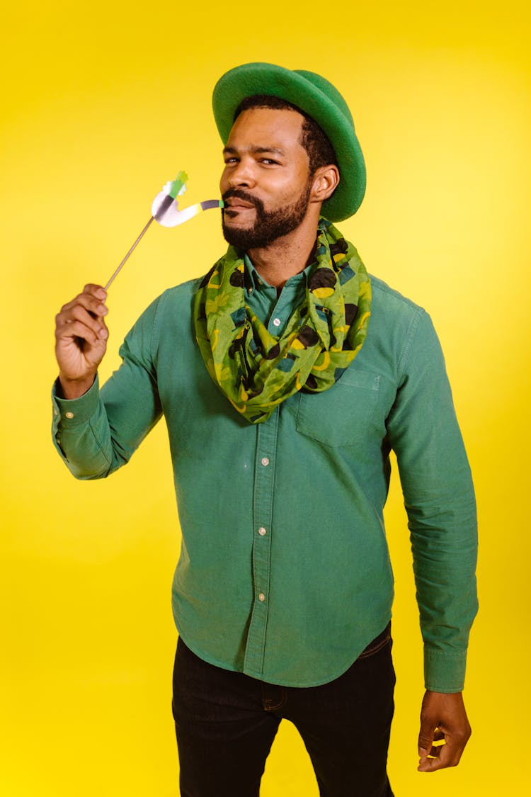 Man Wearing Green Hat Playing With A Prop 