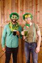 Smiling Men holding Clear Glass Mug with Green Beer