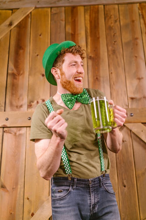 A Man Smiling While Holding a Mug