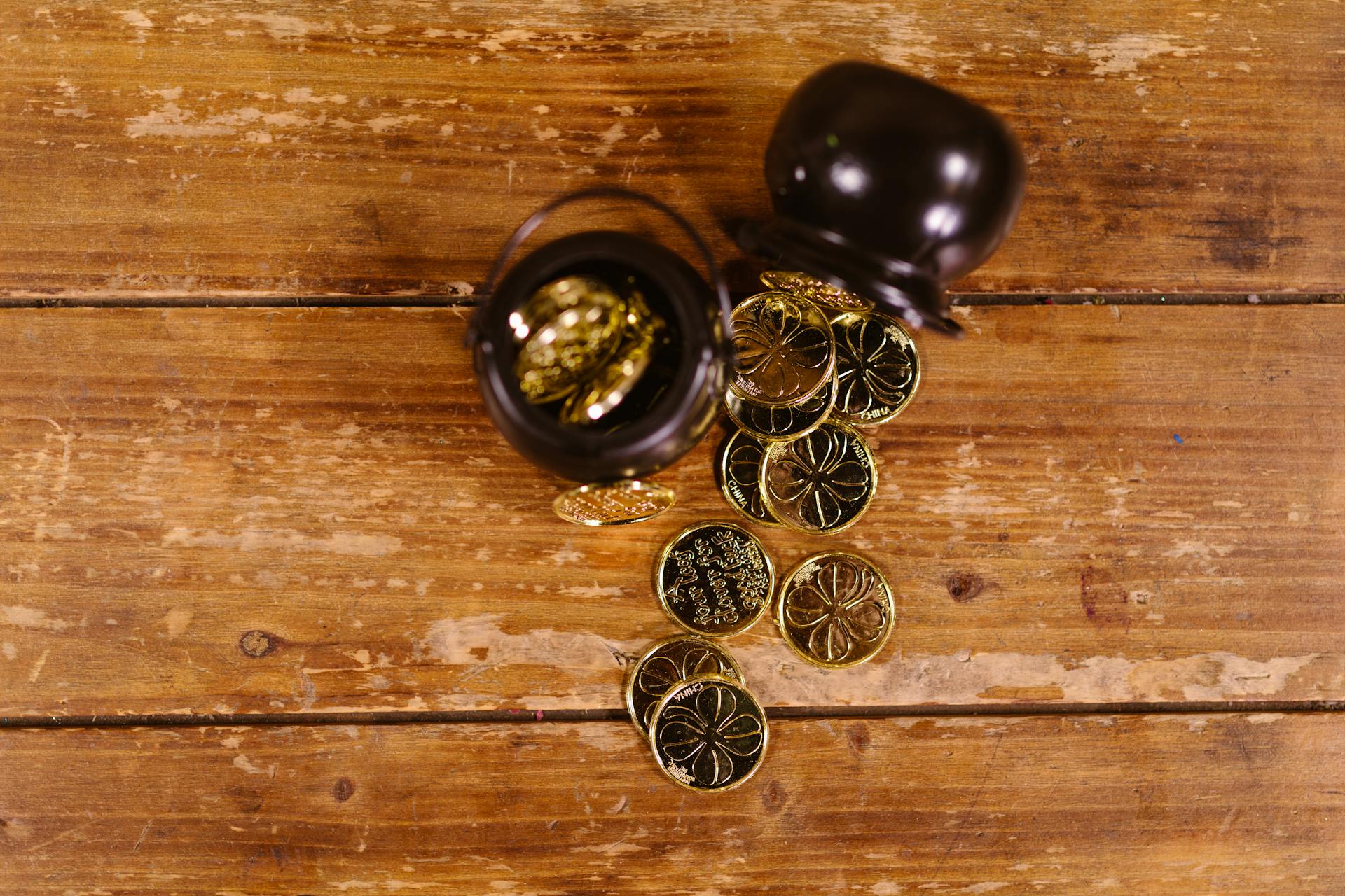 Close-up Photo of Gold Coins on Wooden Surface