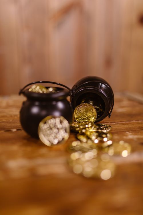 Free Close-up of pots filled with gold coins symbolizing luck and prosperity for St. Patrick's Day. Stock Photo
