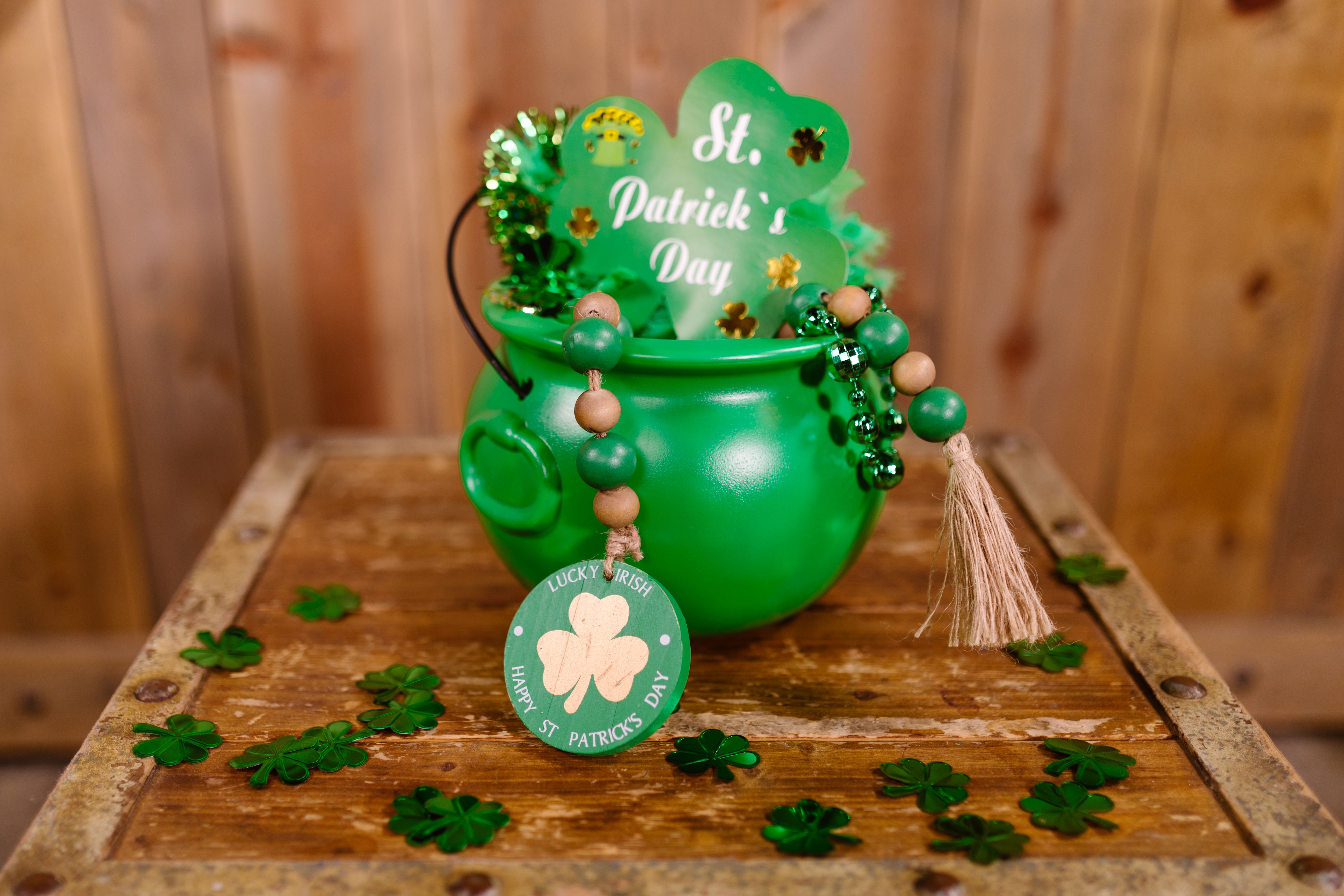 Close-up of a festive green pot filled with decorations for St. Patrick's Day celebrations.
