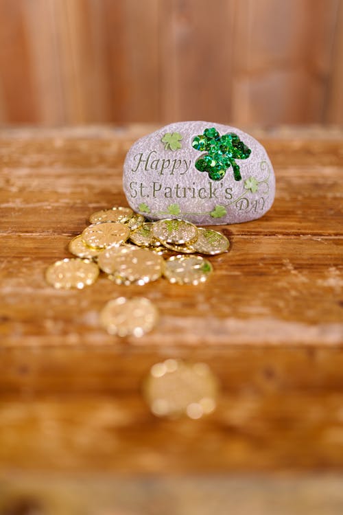 Gold Coins on Wooden Surface in Tilt Shift Lens 