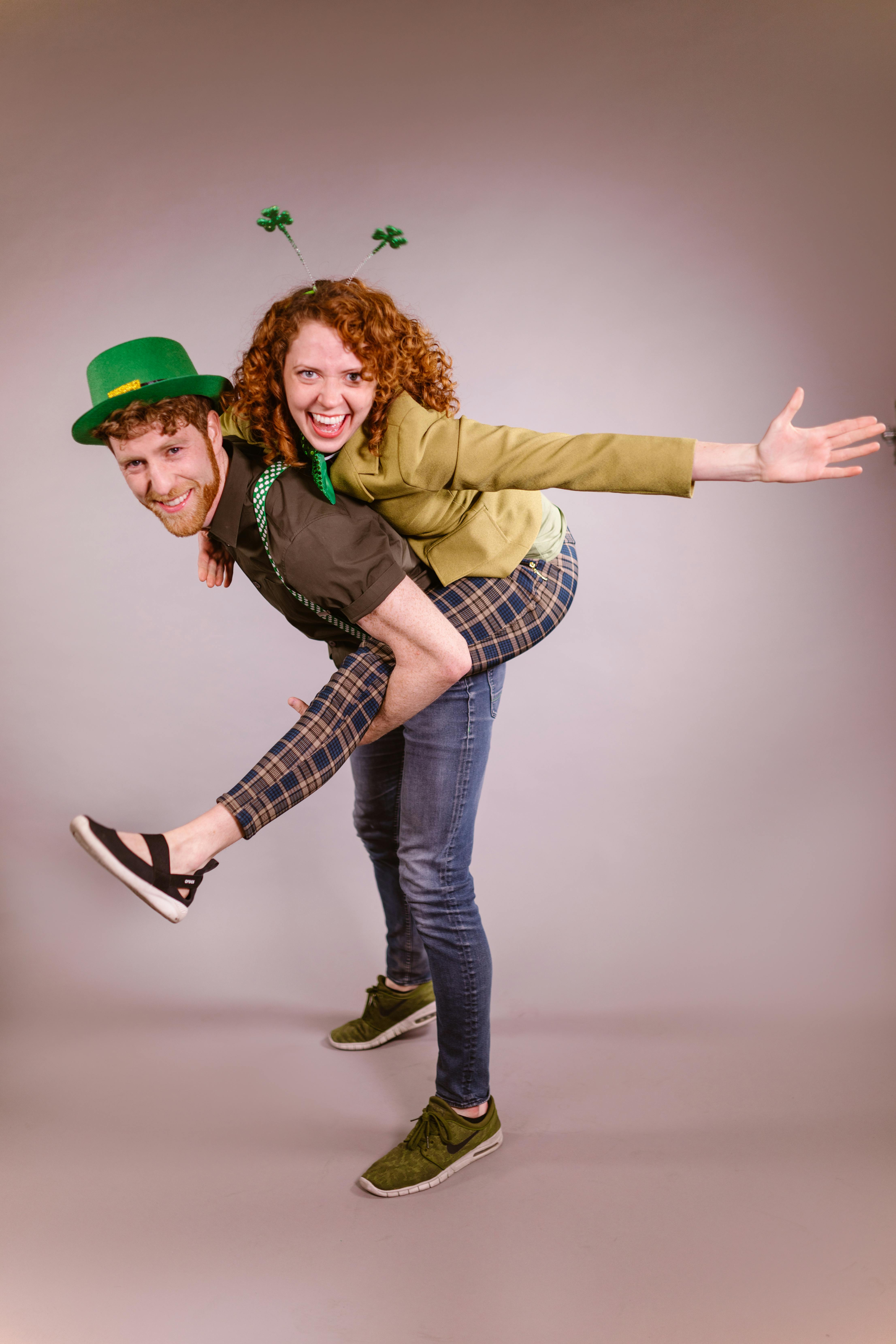 A cheerful couple celebrating St. Patrick's Day with festive attire and playful poses.